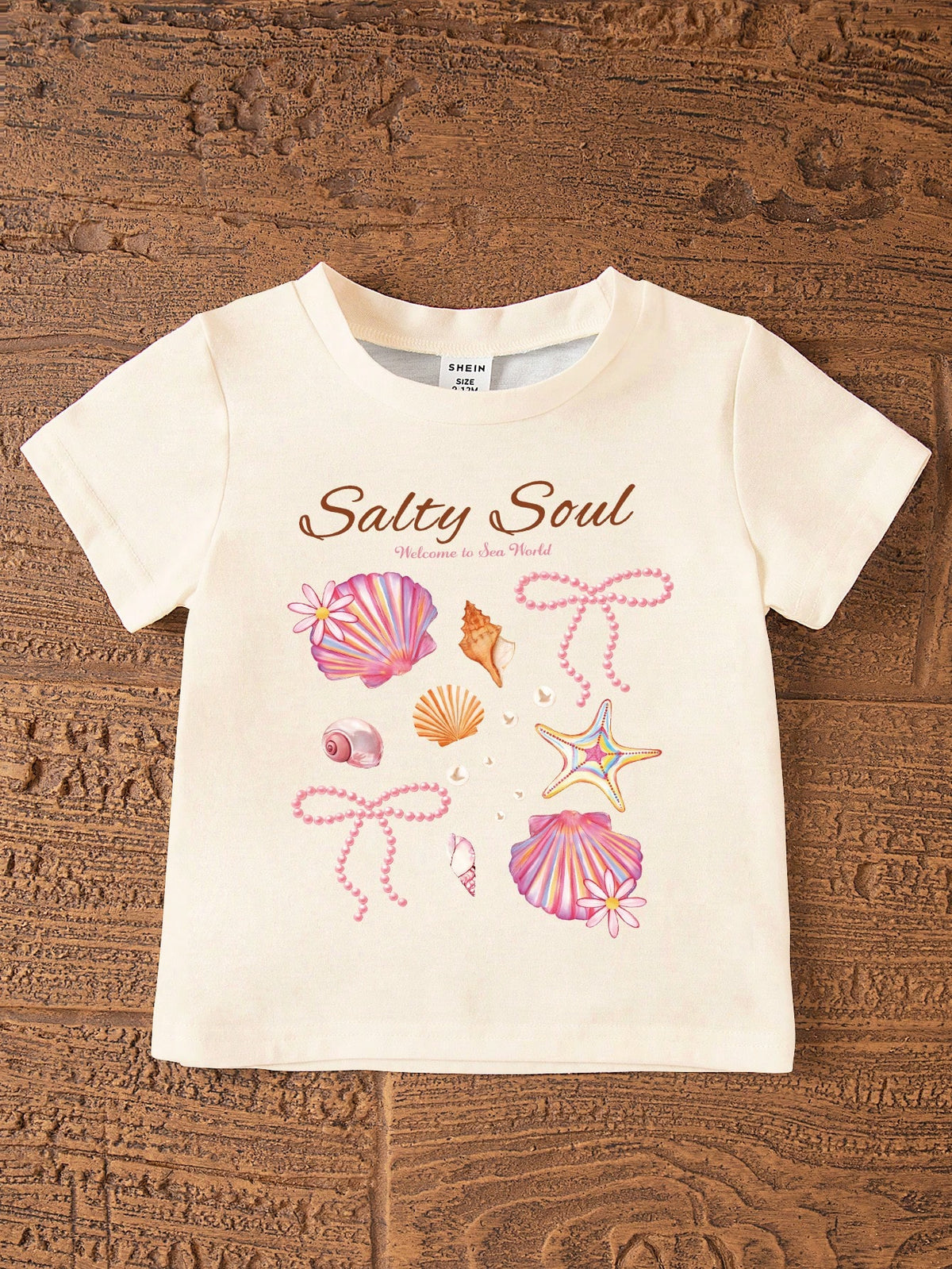 2pcs/Set Cute Baby Girls Beige Summer Outfit,Ocean Creature Shell Bow Print Round Neck T-Shirt And Fitted Bike Shorts,Vacation Holiday Beach Set