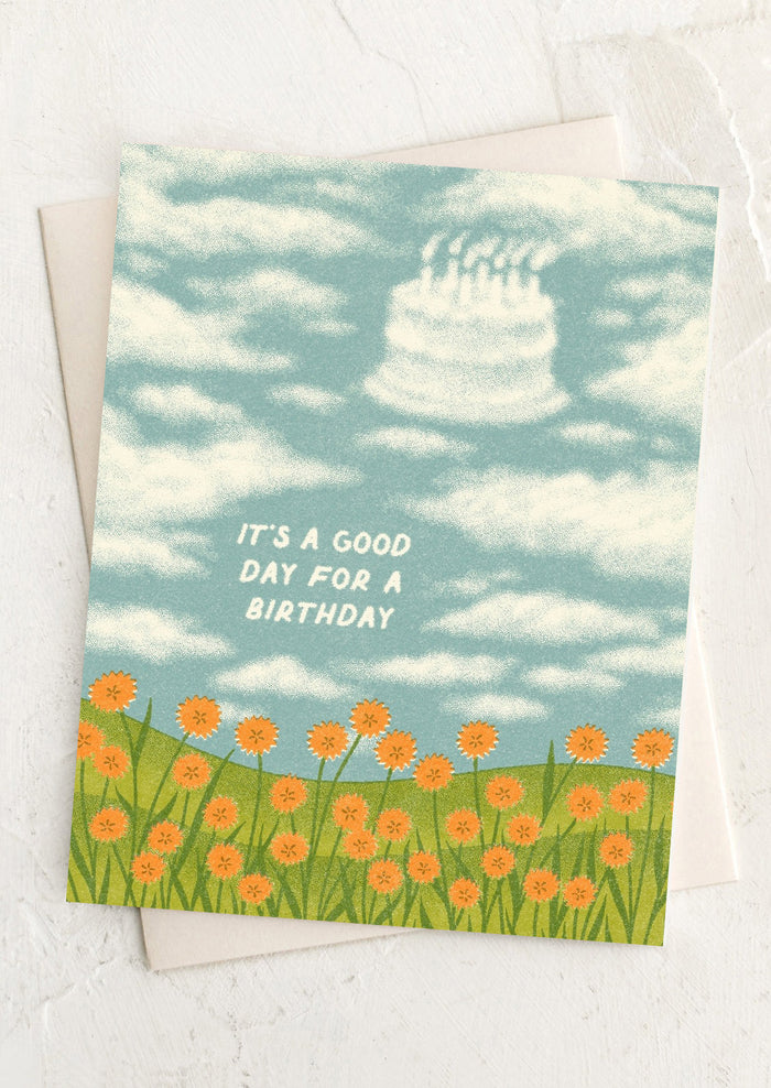 Birthday card with cake in the sky and flowers on a white background
