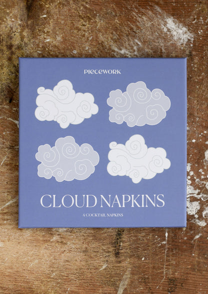 Pack of cloud-shaped napkins on a wooden surface