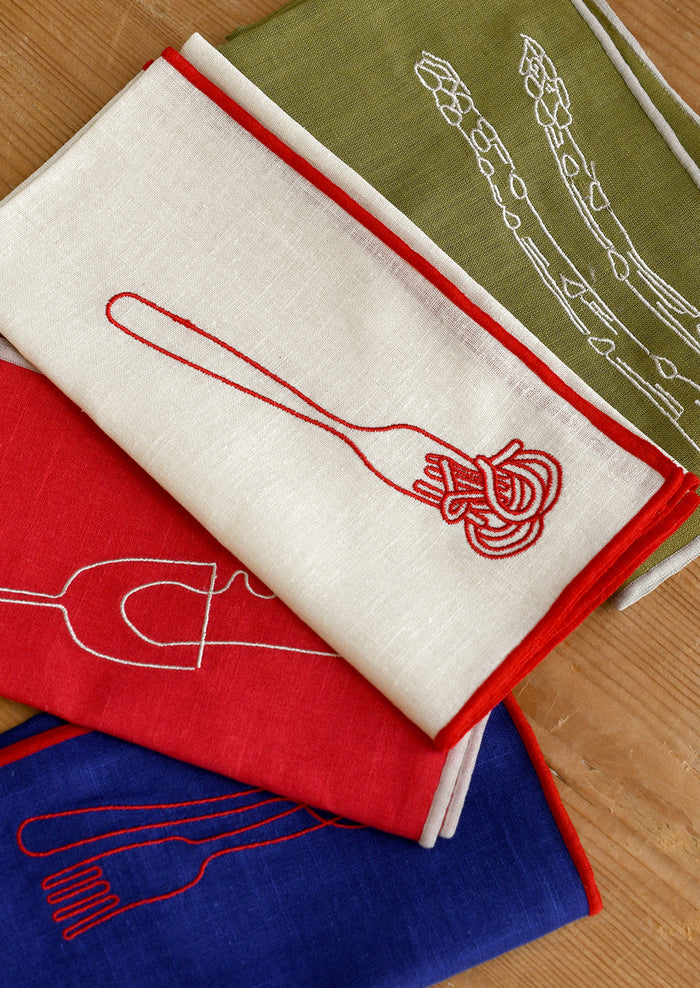 Assorted cloth napkins with food themed embroidered motifs.