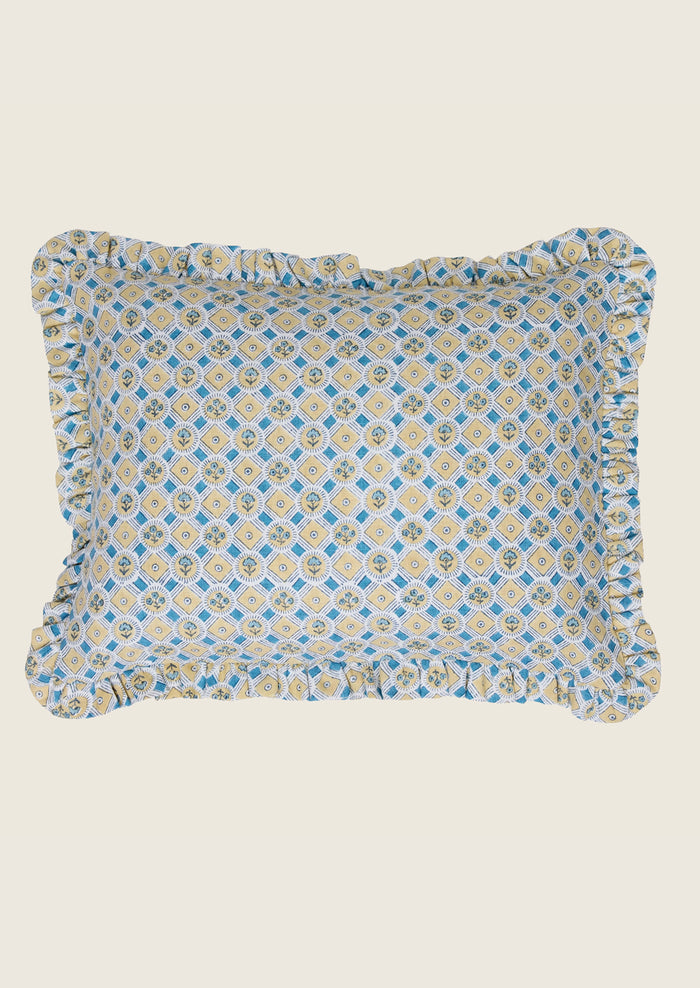Decorative pillow with blue and yellow pattern on a beige background