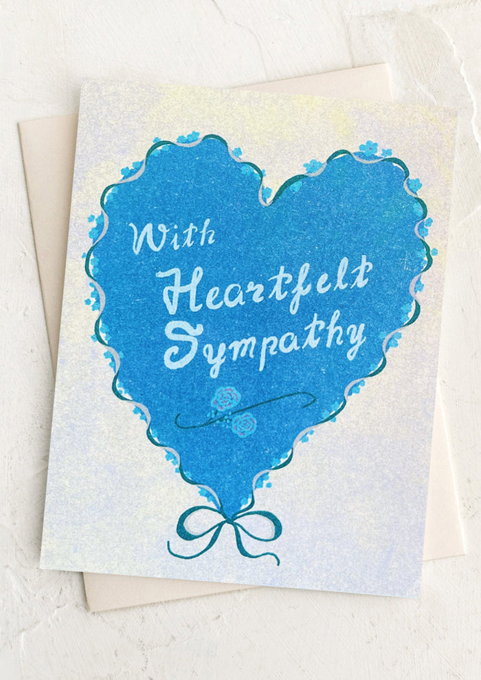 Card with blue heart shape and 'With Heartfelt Sympathy' text on a white background