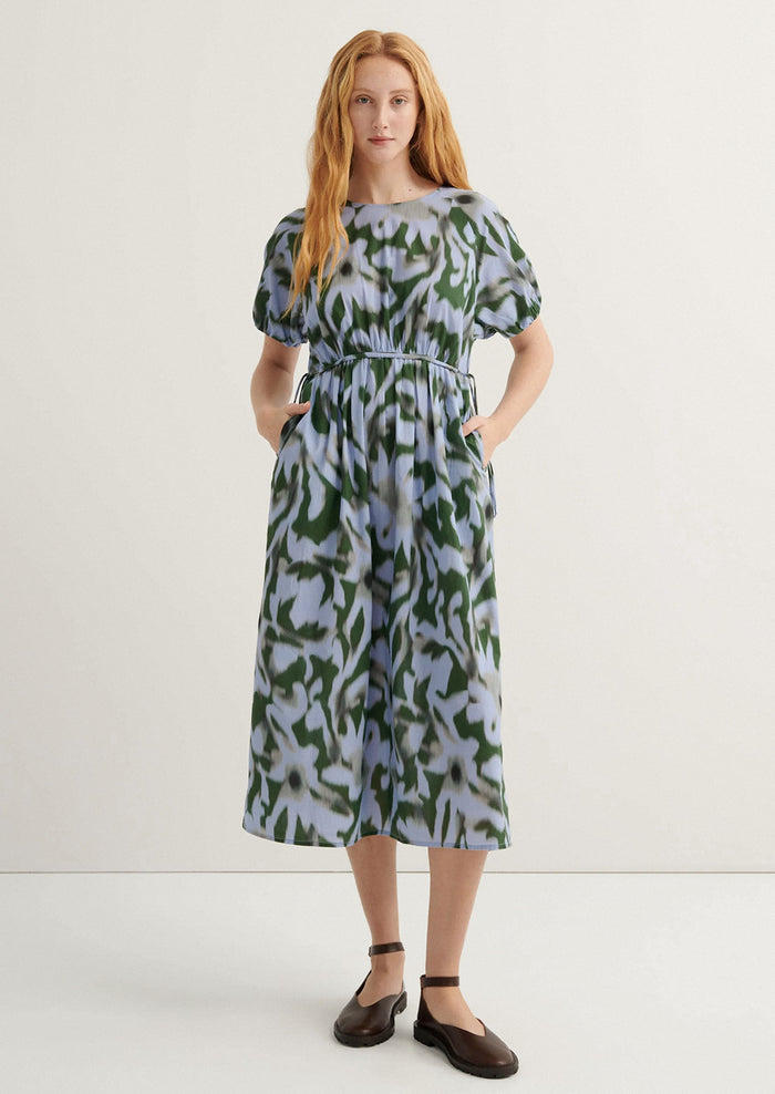 Woman wearing a patterned dress on a white background