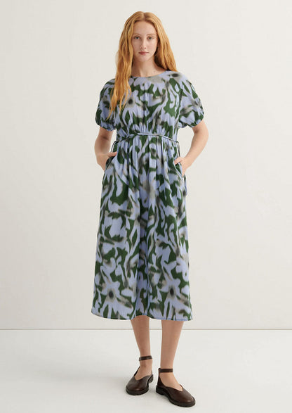 Woman wearing a patterned dress on a white background