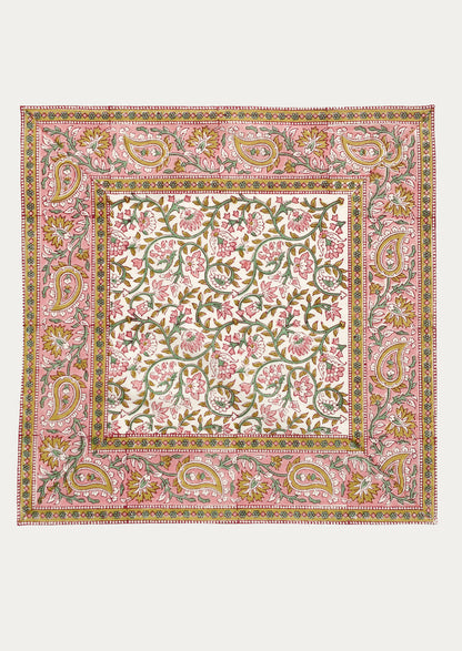 A set of cloth napkins in pink and mustard paisley print.