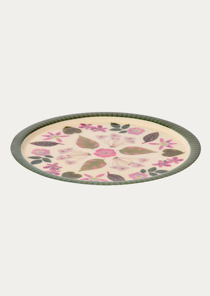 Round decorative plate with floral pattern on a white background