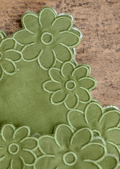 Green floral napkin on a wooden surface