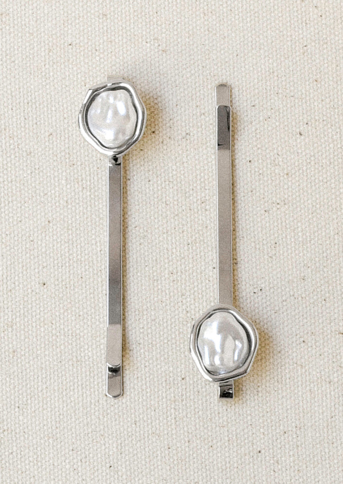 A set of 2 silver hair pins with a faux freshwater pearl on the end of each.
