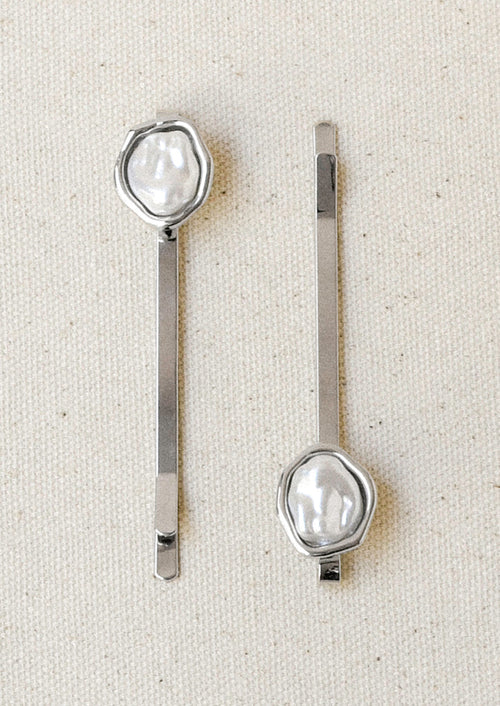 A set of 2 silver hair pins with a faux freshwater pearl on the end of each.