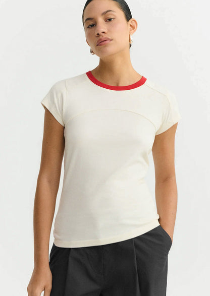 Woman wearing a white t-shirt with red trim on a white background