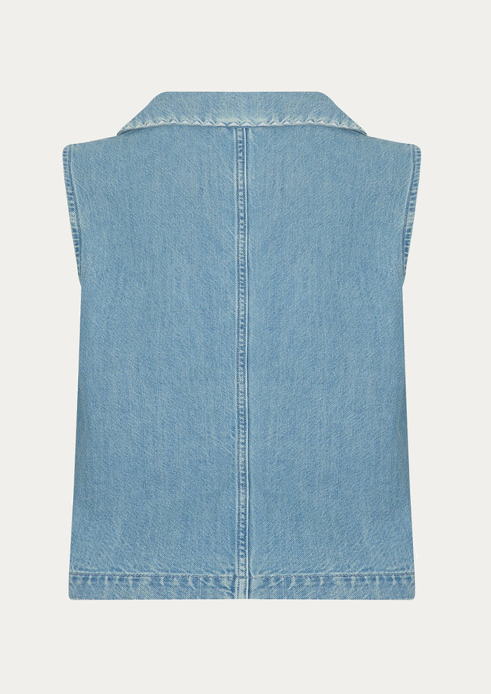 A sleeveless button front top with pointed collar, in light wash denim.